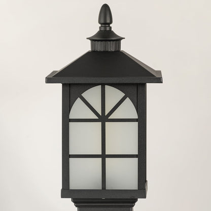 Closeup of black outdoor gate light with arched frosted glass panels for luxury decor styling.