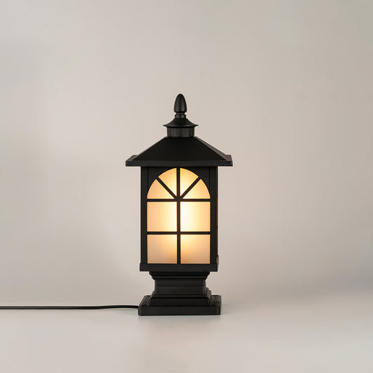 Black outdoor gate light with warm glowing glass panels for elegant exterior decor styling use.