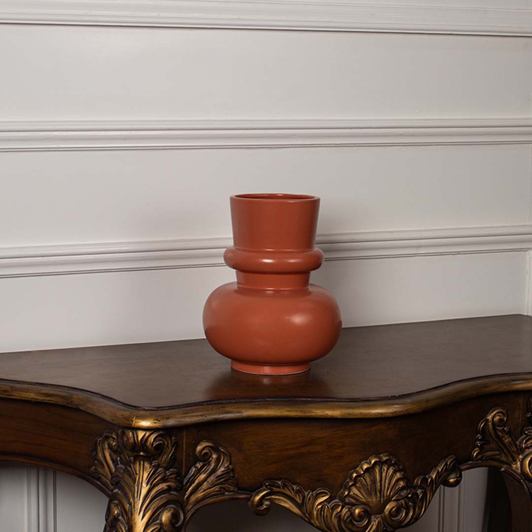 Terracotta orange modern decorative vase displayed on a clean white background highlighting its sculptural shape for modern home decor.
