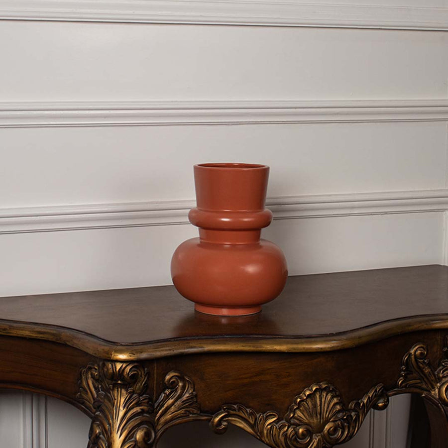 Terracotta orange modern decorative vase displayed on a clean white background highlighting its sculptural shape for modern home decor.
