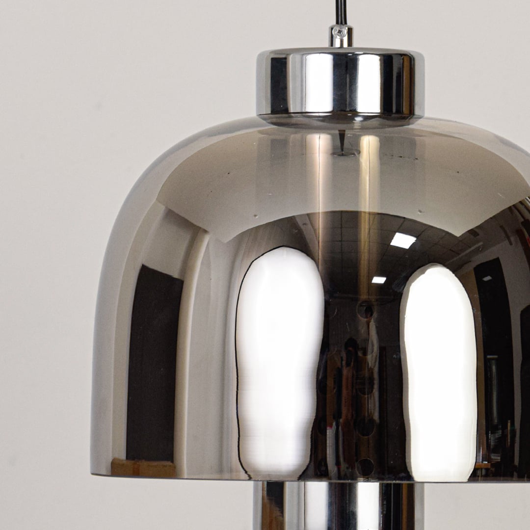 Closeup of smoke glass and chrome metal pendant light showcasing reflective finish and craftsmanship.