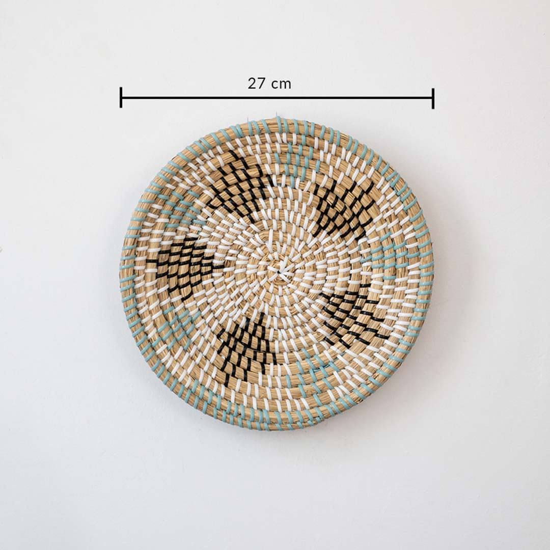 Handwoven seagrass round wall basket decor in natural beige with green leaf pattern and size guide on white background.