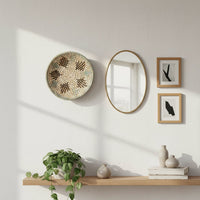 Natural woven wall basket styled above a console table for artistic wall decor and contemporary home interiors.