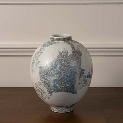 Round ceramic vase with textured grey and blue artistic finish styled for modern home decor on plain white background display.