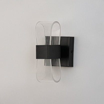 Black wall light with curved acrylic shade presented on a white background with lights off.