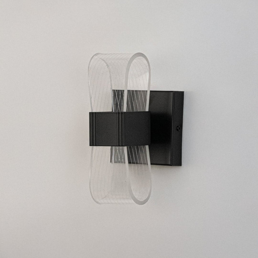 Black wall light with curved acrylic shade presented on a white background with lights off.