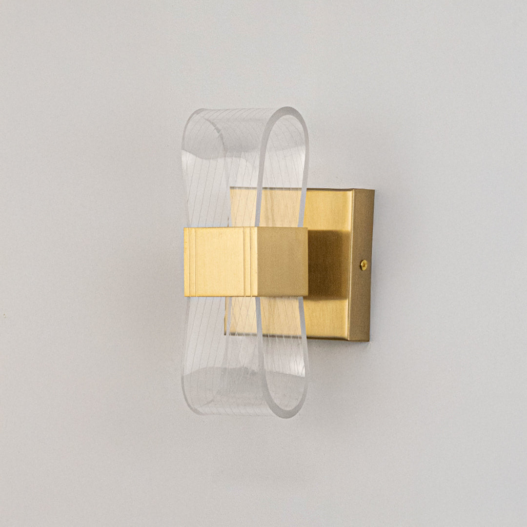 Contemporary wall light in gold metal finish with layered glass design for bedroom or living decor lighting placement white background.