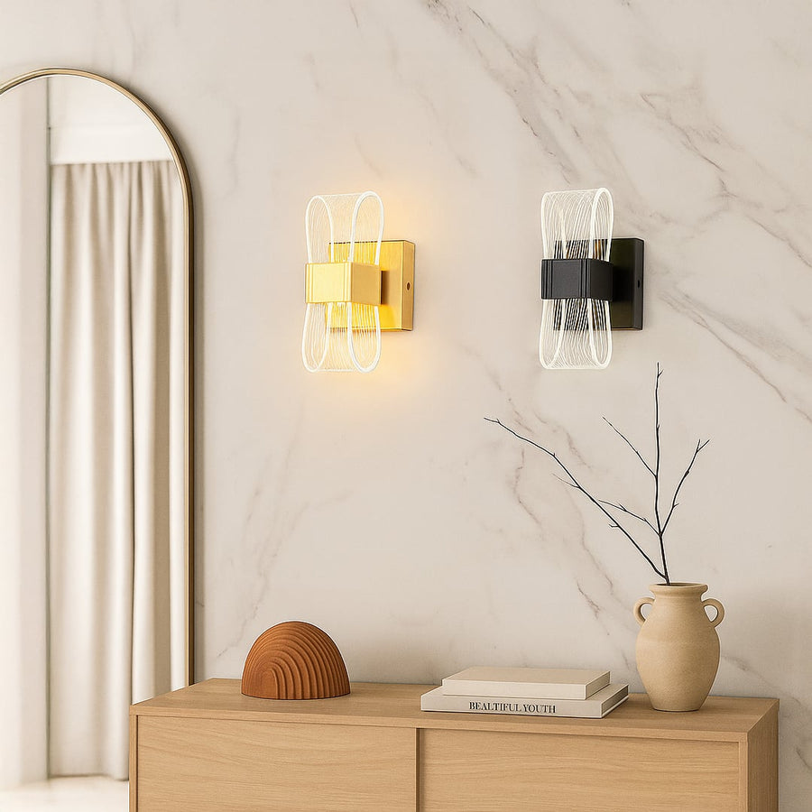 Gold metal wall light with ribbed clear glass shade adding warm ambient lighting to a modern stylish interior.
