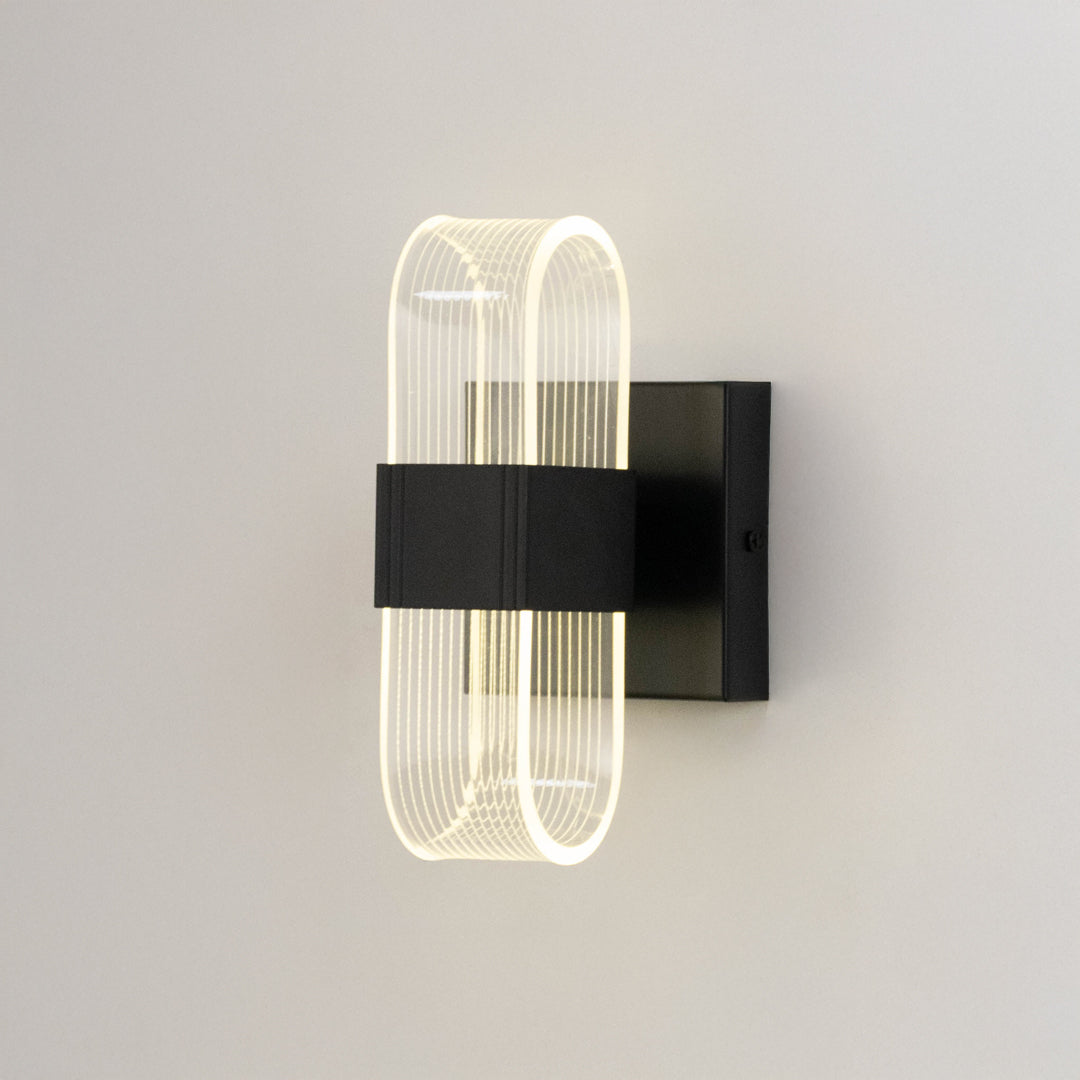 Minimal wall light in black metal finish with sculpted glass design for bedroom or living room decor lighting white background.