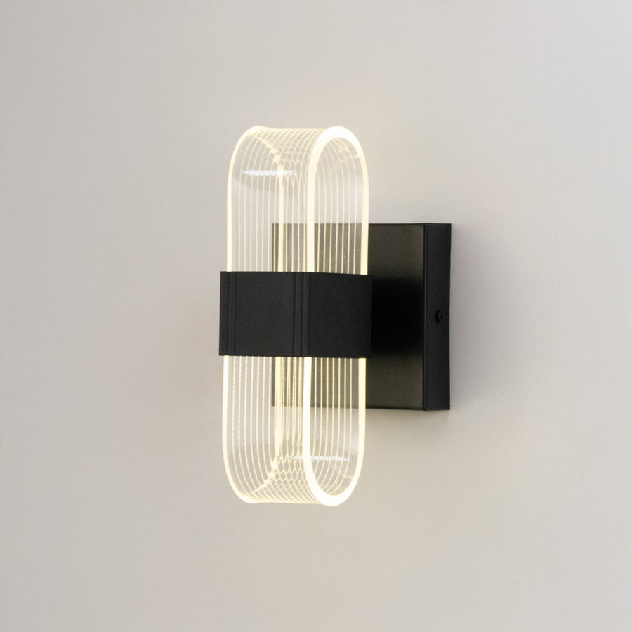 Minimal wall light in black metal finish with sculpted glass design for bedroom or living room decor lighting white background.
