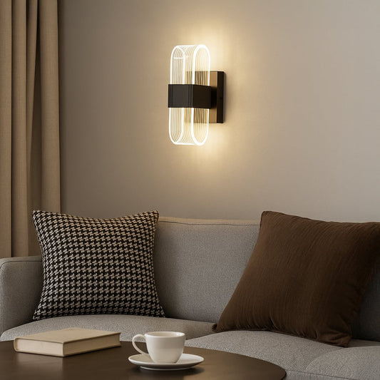 Black metal wall light with ribbed clear glass shade adding modern ambient lighting to a stylish home interior.