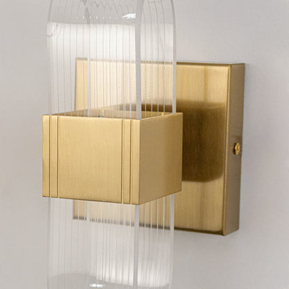 Decorative wall light in gold metal finish with textured glass panels for bedroom or living decor lighting placement white background.