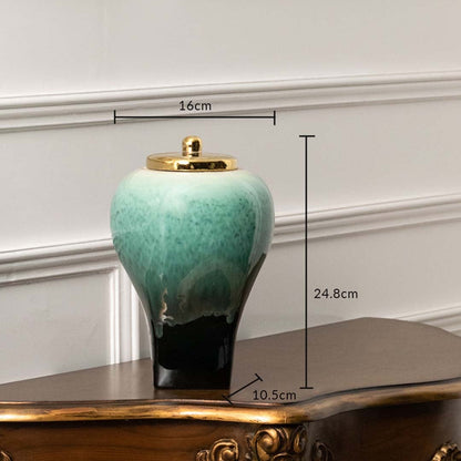 Green ceramic decor jar with black base and gold lid measuring 24.8 cm height 16 cm width and 10.5 cm base for tabletop decor.