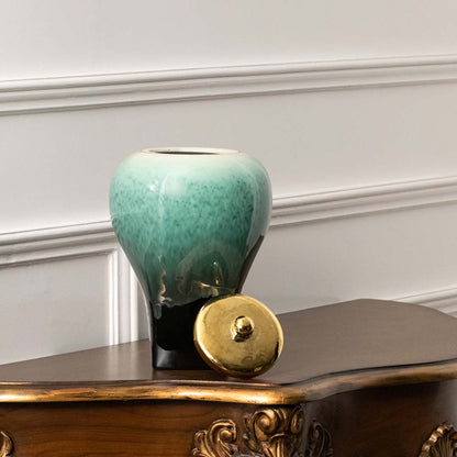 Green ceramic decorative vase styled on a console table for elegant contemporary home decor and tabletop styling.