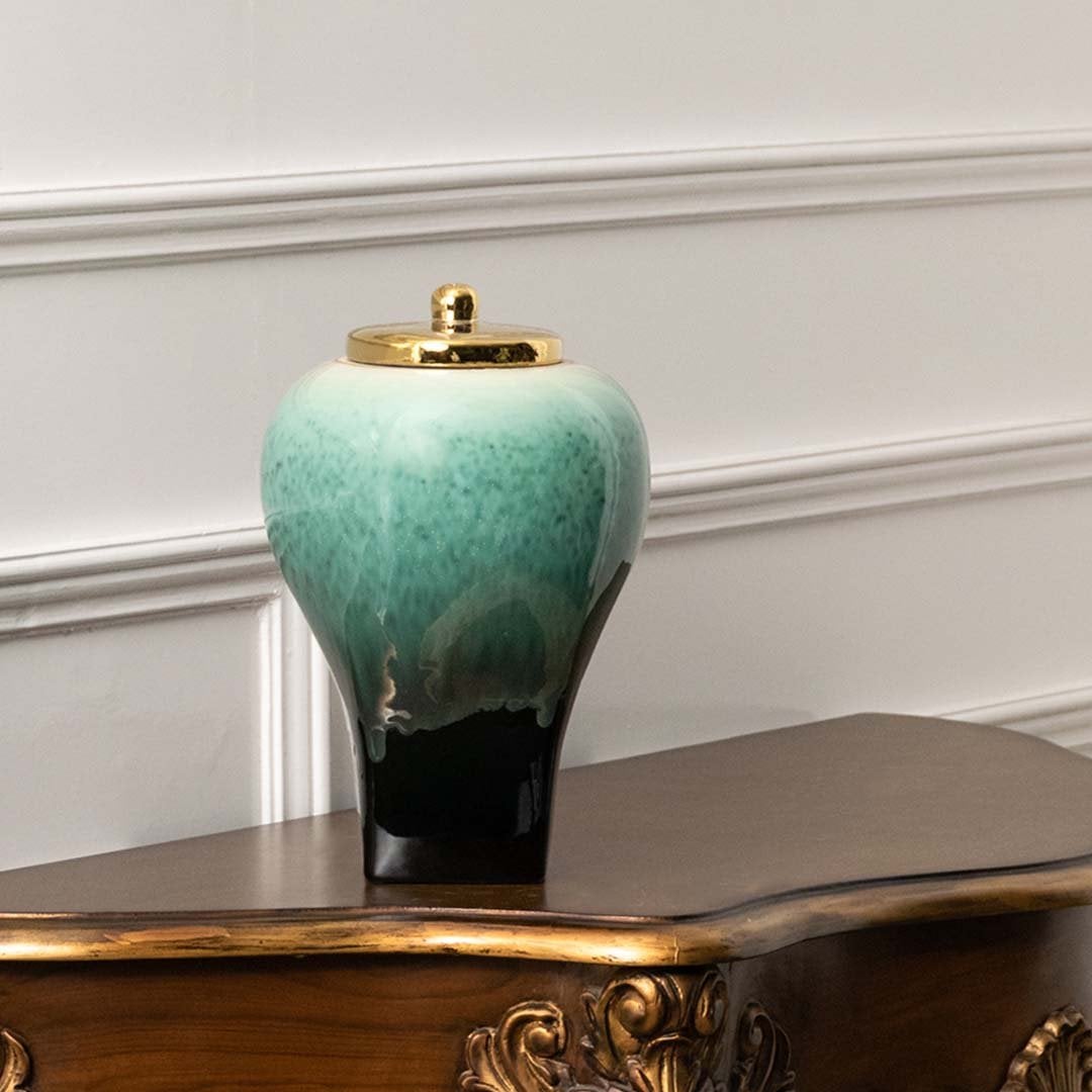 Premium ceramic decorative jar in green and black tones with gold lid crafted for tabletop accent in elegant home decor.
