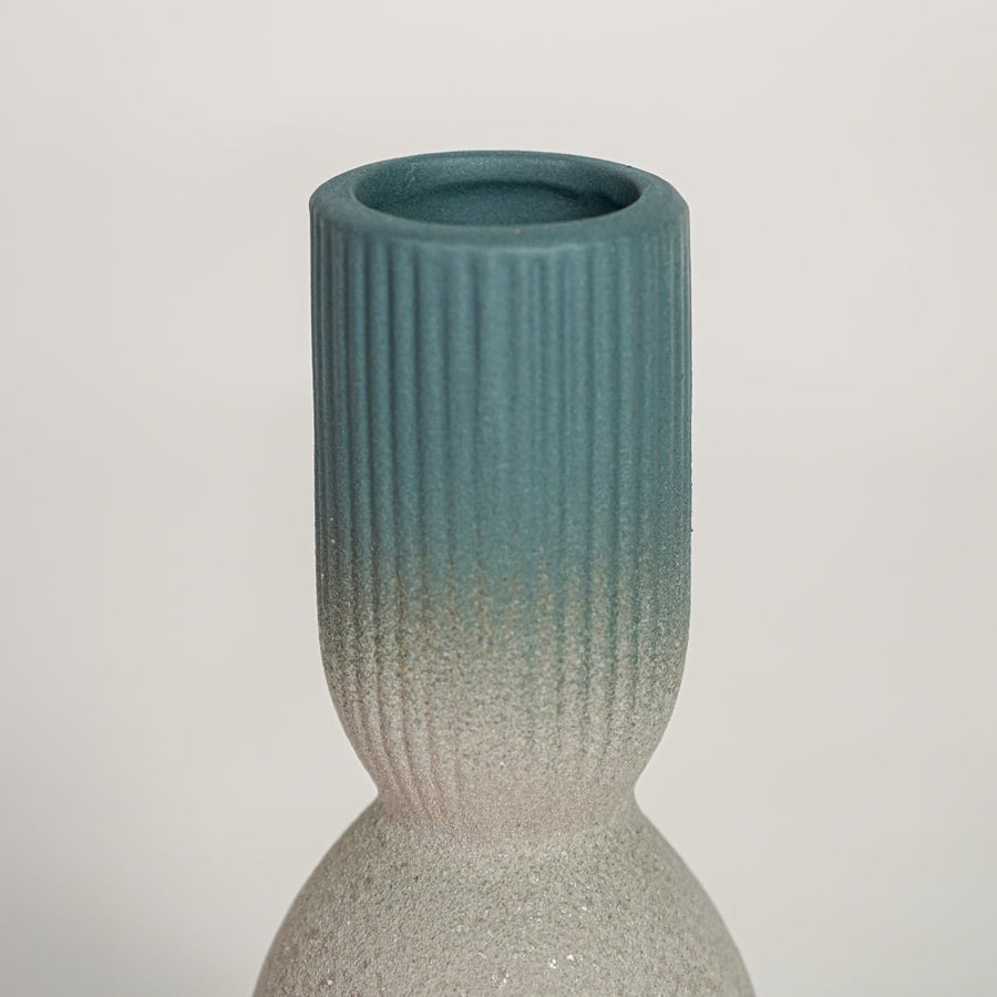 Detailed view of beige textured ceramic vase with smooth blue glazed neck showcasing modern handcrafted home decor styling.