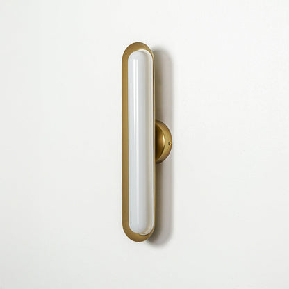 Minimal gold wall light with slim oval LED design mounted on neutral wall background perfect for modern home decor lighting.

