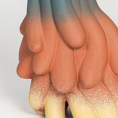 Close up view abstract ceramic sculpture showing flowing layered texture matte finish artistic modern decor accent.
