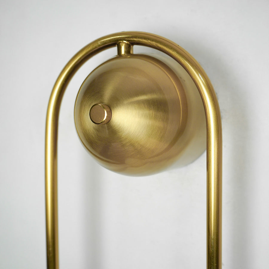 Closeup image of brushed gold metal wall light base for elegant modern decorative interior lighting decor.