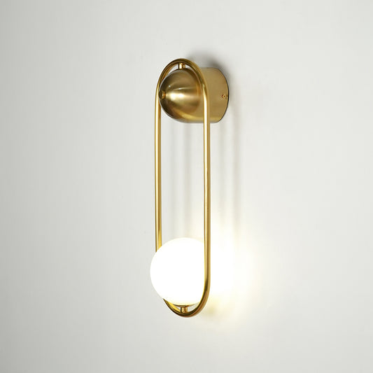 Gold metal wall light on white background with frosted globe shade for modern luxury wall decor.