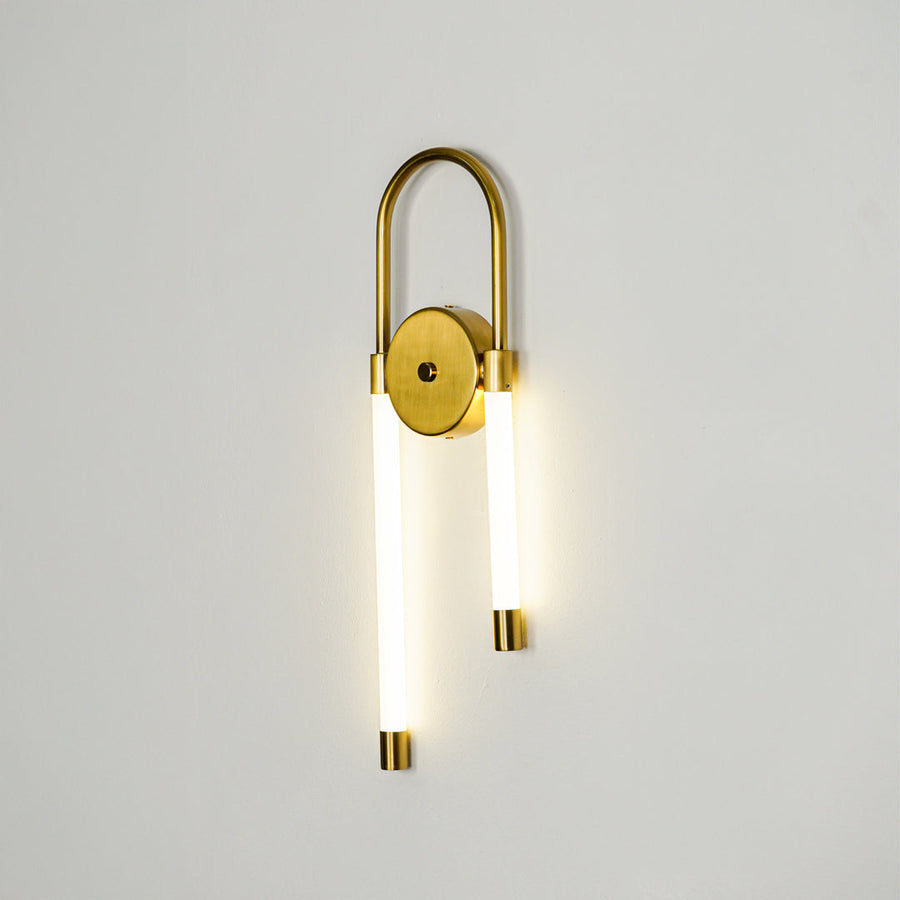 Minimal gold wall sconce with cylindrical white glass shades on clean background perfect for modern interior accent lighting setup.
