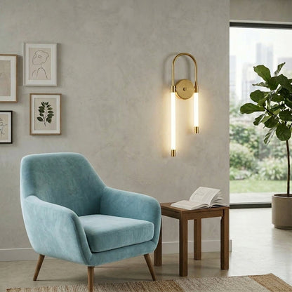 Gold wall light with looped LED tube mounted on neutral wall beside blue armchair and wooden table ideal for modern living room decor.