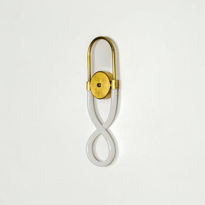 Elegant gold wall sconce with infinity shape LED tube mounted on soft neutral wall background perfect for modern decorative lighting setup.