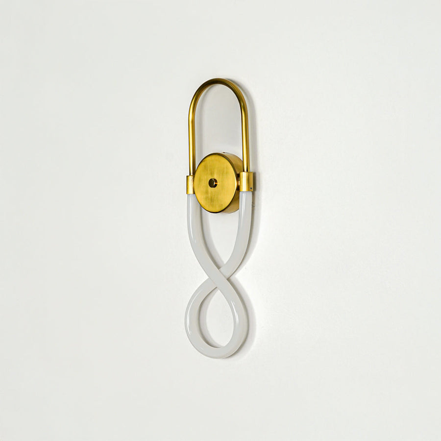 Elegant gold wall sconce with infinity shape LED tube mounted on soft neutral wall background perfect for modern decorative lighting setup.