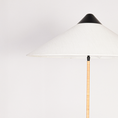 Closeup of floor lamp stacked turned base with smooth finish highlighting craftsmanship texture and elegant detailing under soft ambient lighting.
