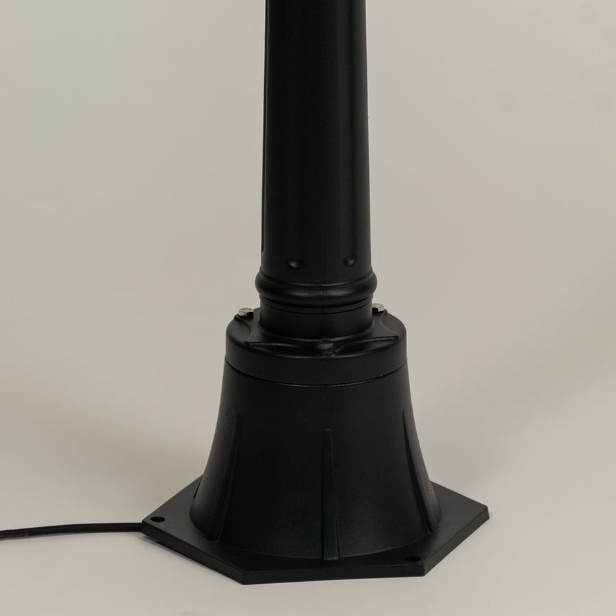 Closeup of outdoor lamp base in black metal finish highlighting sturdy pedestal design durable build and classic detailing.