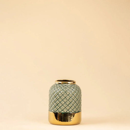 Green ceramic decor jar with textured finish and gold lid perfect for modern shelf or table decor styling in home interior.