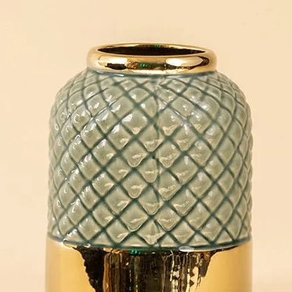 Green textured ceramic decorative jar closeup highlighting diamond pattern glaze and gold rim detail for luxury tabletop decor accent.