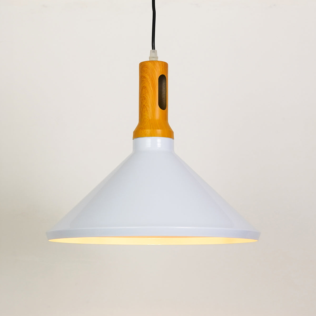 White background image of illuminated arden modern wooden pendant light in white for elegant dining room decor room styling.