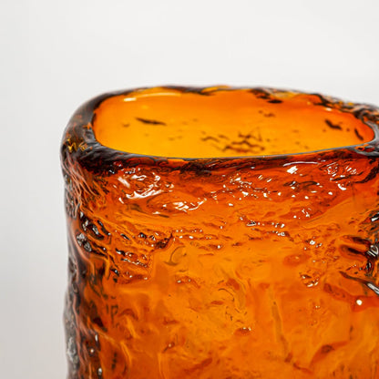 Close up view amber textured art glass vase showing sculpted surface glossy finish decorative glass accent for shelf styling.