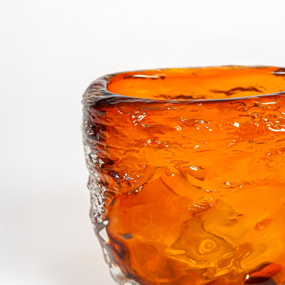 Close view amber textured art glass vase showing sculpted surface glossy finish decorative glass accent for shelf styling home.