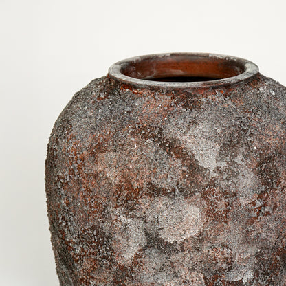 Closeup image of black ceramic rustic vase for modern interior decor styling with artistic textured finish.