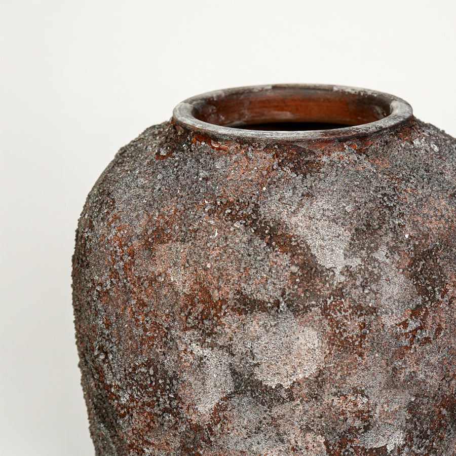 Closeup image of black ceramic rustic vase for modern interior decor styling with artistic textured finish.