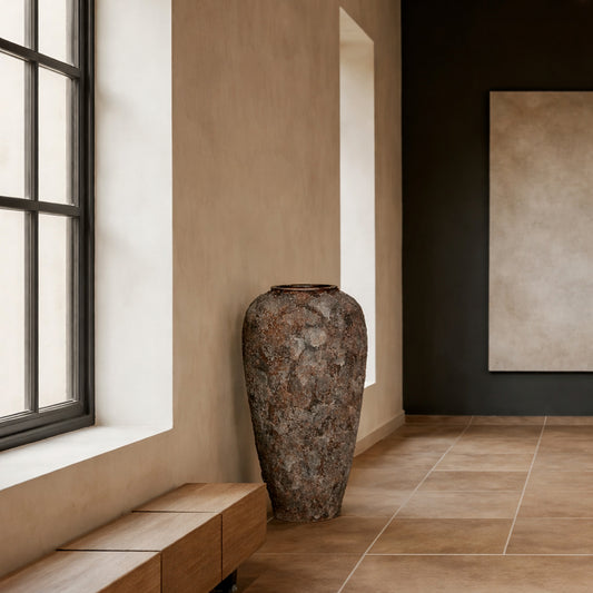 Lifestyle image of black ceramic floor vase for modern hallway decor styling with rustic textured finish.
