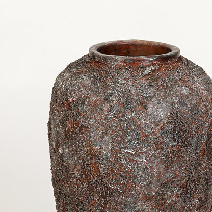 Closeup image of black ceramic floor vase for modern interior decor styling with textured rustic finish.