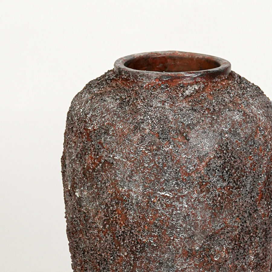 Closeup image of black ceramic floor vase for modern interior decor styling with textured rustic finish.