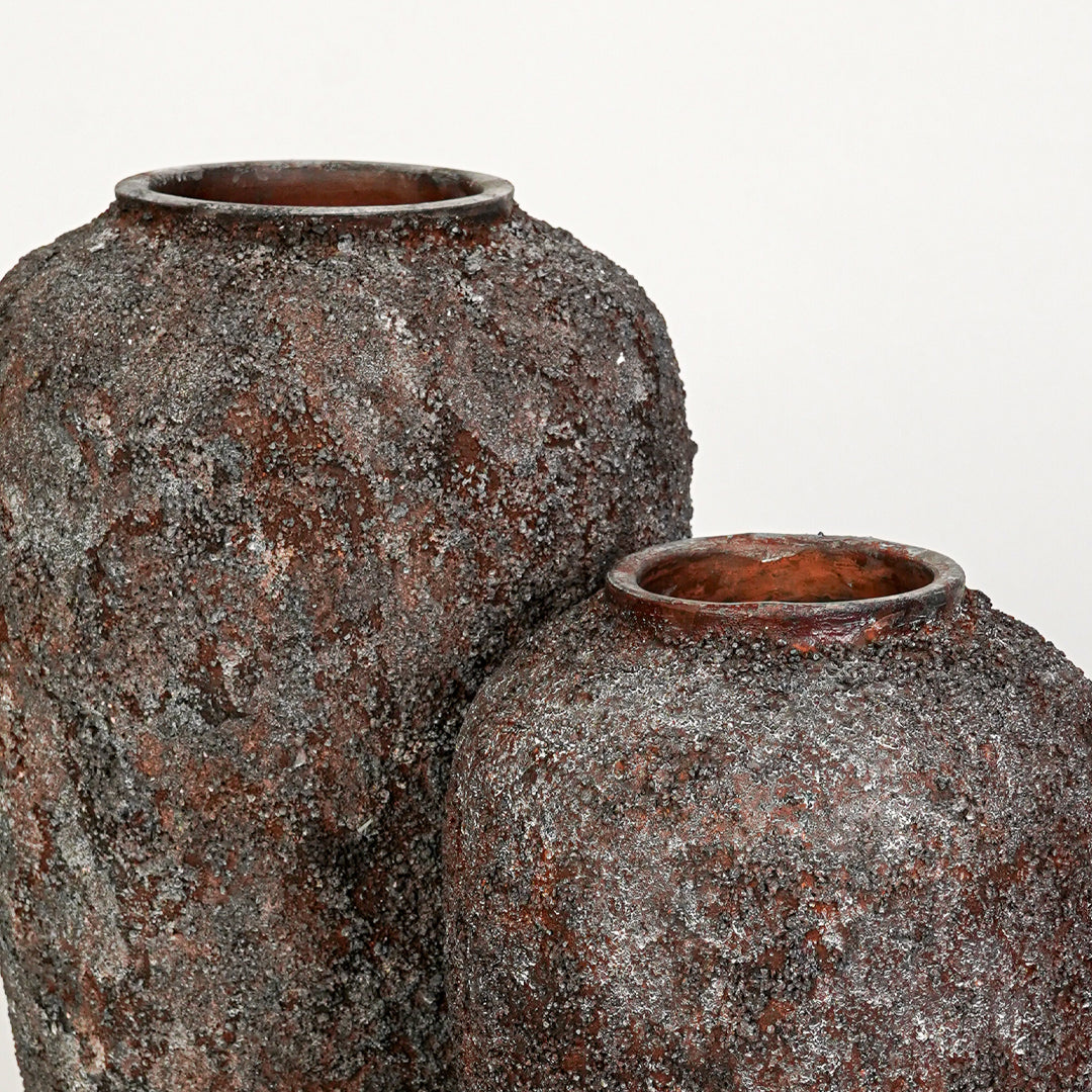 Closeup image of black ceramic vase set for modern living room decor styling with rustic textured finish.