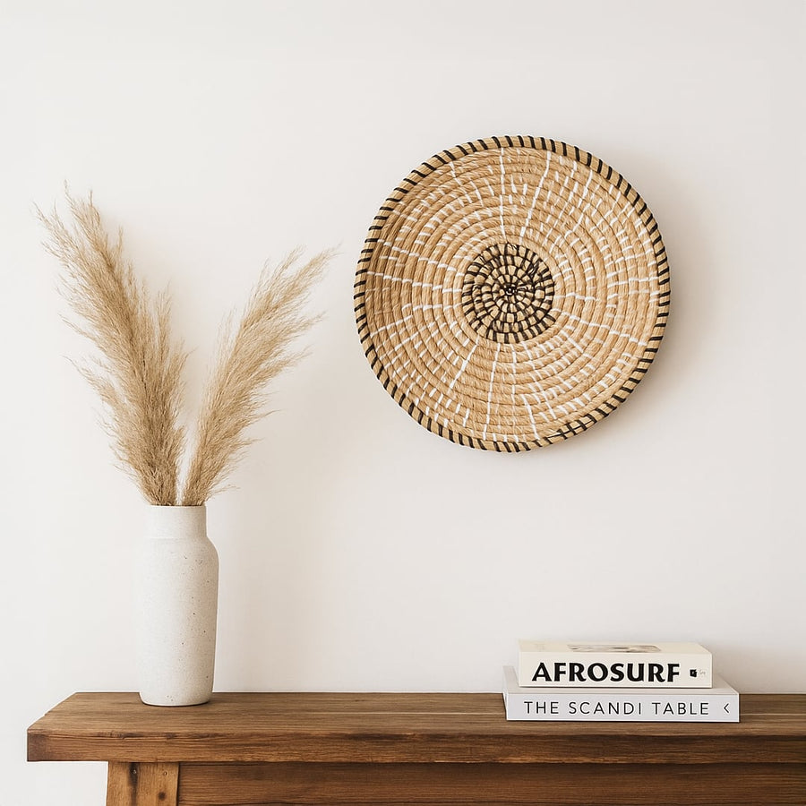 Natural woven wall basket displayed on a wooden shelf for elegant bohemian wall decor and modern home interiors.