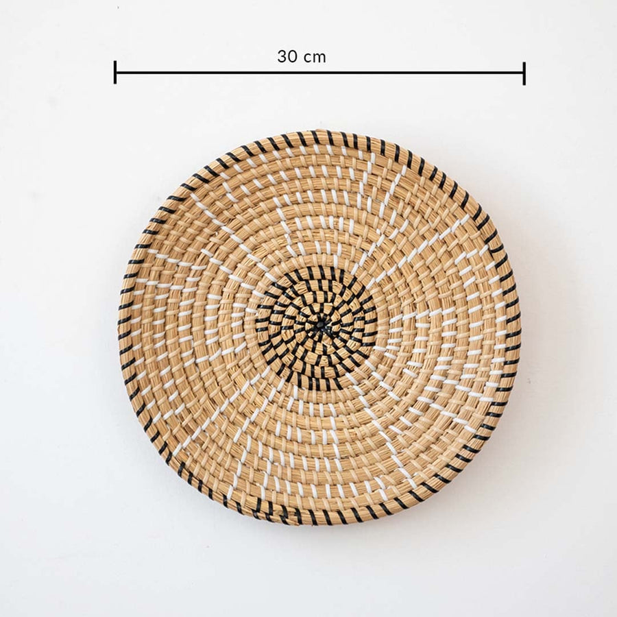 Decorative wall basket handwoven in natural cane with black details measuring 30 cm diameter for wall decor.