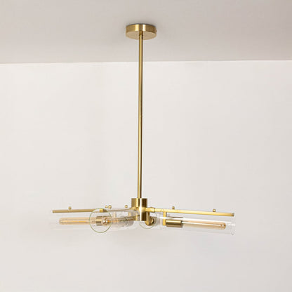 Gold molecular chandelier with clear glass tube shades turned off on white background displaying modern industrial fixture.