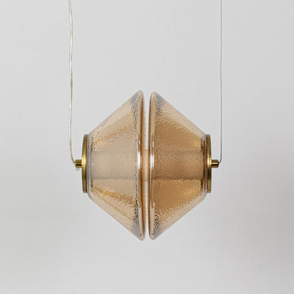 A hammered glass pendant light presented with the light off revealing the sculpted glass form and gold elements against a simple white backdrop.