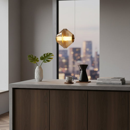 A modern dining space with a warm glowing hammered glass pendant light hanging above a table set with minimal decor creating a calm inviting atmosphere.