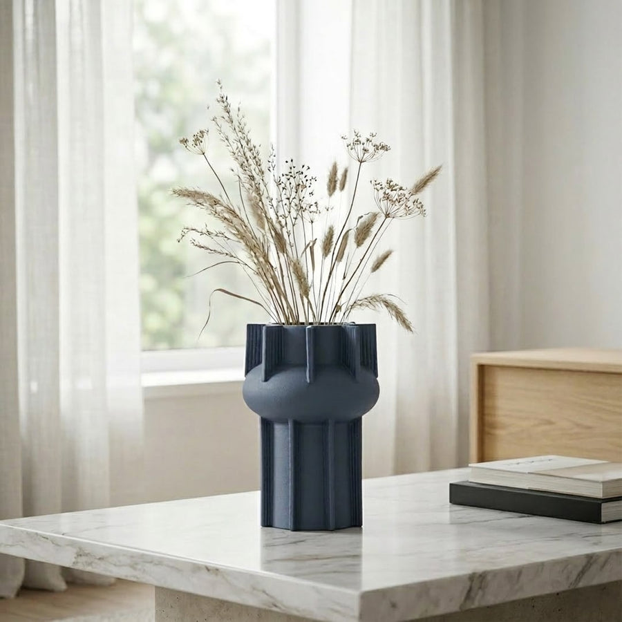 Blue ceramic flower vase placed on marble table modern decorative vase for living room console home decor styling.