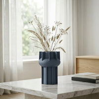 Blue ceramic flower vase placed on marble table modern decorative vase for living room console home decor styling.