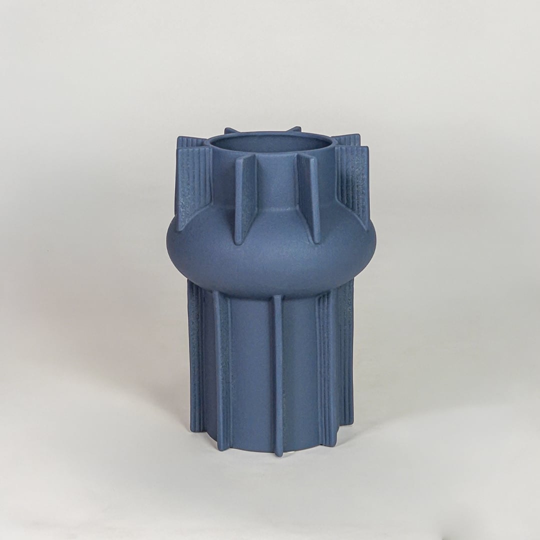 Blue ceramic flower vase with textured modern design decorative vase for tabletop shelf console living room decor styling.