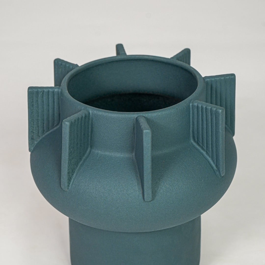 Green ceramic flower vase closeup with textured pattern modern decorative vase for shelf console table decor styling.